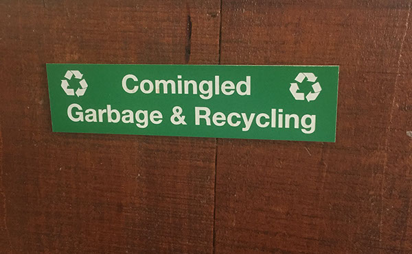 Green acrylic piece with white letters engraving sign