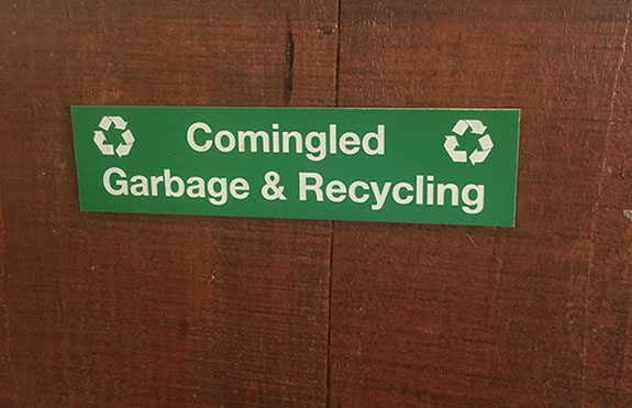 Green acrylic piece with white letters engraving sign